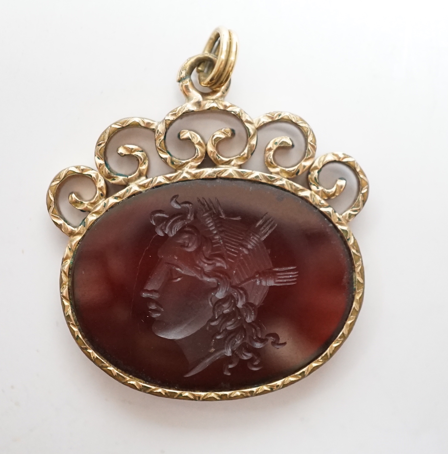 A yellow metal mounted oval intaglio agate? pendant, carved with the bust of a lady to dexter, width 26mm.